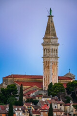Obraz premium Coastline of Adriatic sea and The bell tower of Church of St. Euphemia and the old city of Rovinj, Istria, Croatia in a blue hour twilight dawn.