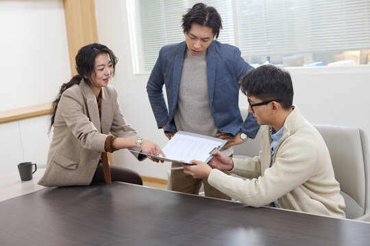 A group of professionals collaborates during a meeting at the office