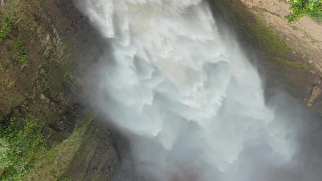 Powerful kabut pelangi waterfall cascading aerial view