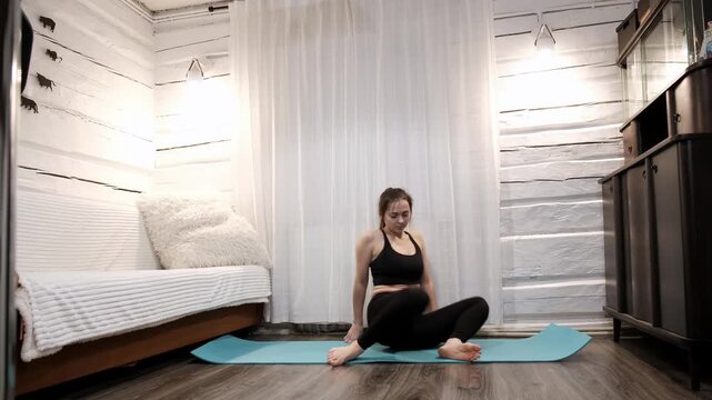 The woman doing a dynamic mermaid pose setting on yoga mat improving hip joint mobility. Person practicing flexibility. Healthy lifestyle concept. Stretching exercise. High quality 4k footage.