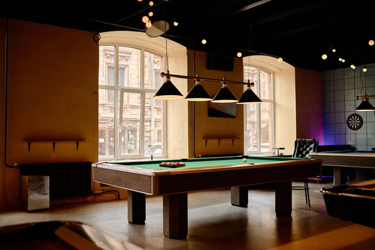 Wide angle shot of billiards table standing in modern entertainment venue, presenting leisure business concept. Suitable for hospitality marketing, bar promotion, event advertising
