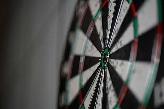 Close up of dartboard showing scoring rings and bullseye, representing focus, precision, goal setting, and performance tracking. Useful for business strategy, target marketing, and success concepts

