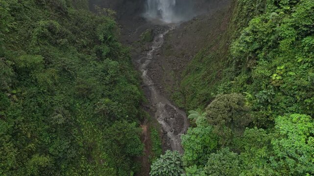 Powerful kabut pelangi waterfall in indonesian rainforest