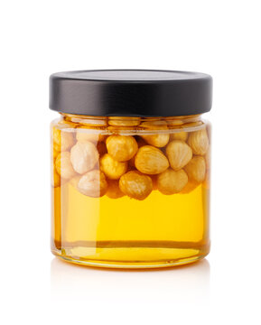 Hazelnuts soaked in honey inside clear glass jar