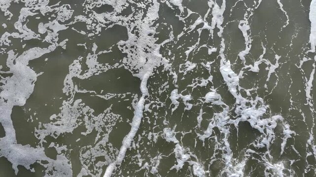 Aerial top-down view of sand and wave boundary at Tomioka beach, minimalist Fukushima