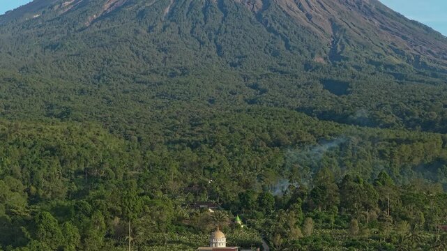 Aerial view of semeru volcano rising above indonesian rainforest