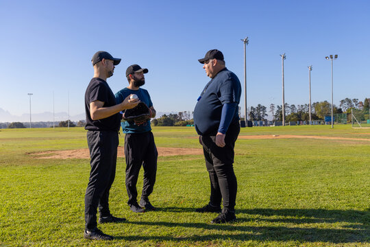 Player with baseball initiating coaching talk on field animated diagram tracing infield near group