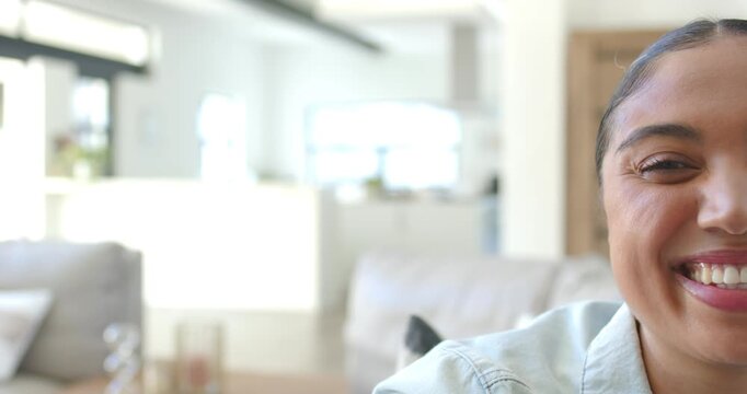 Right-side recording Adult woman smiling into broad laugh at home denim shirt, sofa, copy space