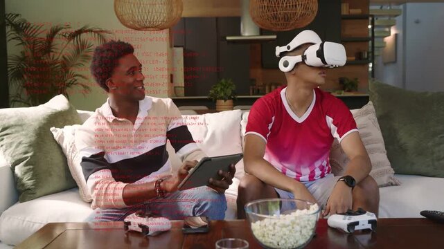 Left man tapping tablet and starting gaming while VR user wearing headset grabbing VR objects