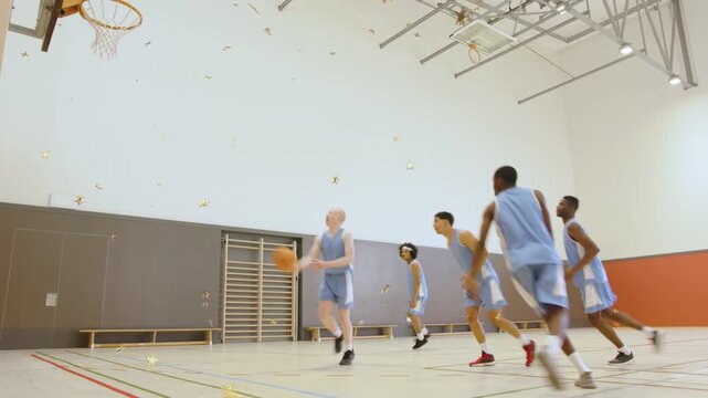 Five male basketball players running offense in gym, left passing to right cutter driving to score