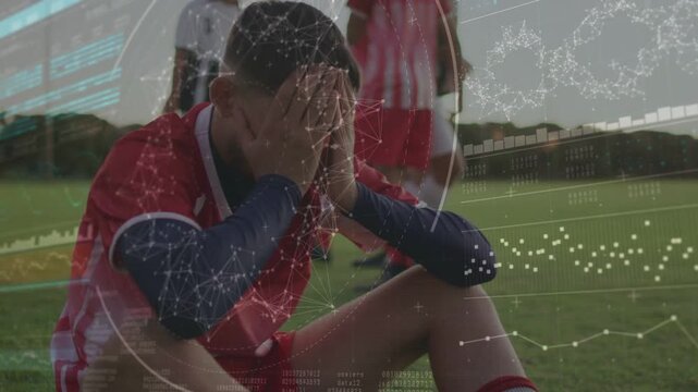 Male soccer player handling item then covering face, reacting to match setback with HUD overlay