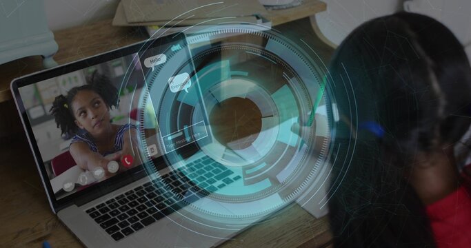 Participating two girls leaning toward laptop in home study, wearing red and striped tops with HUD