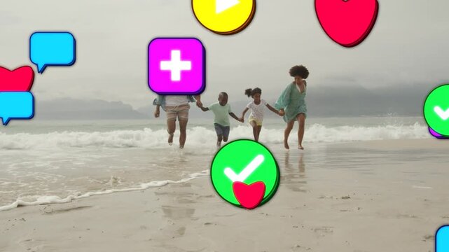 Family of four running toward camera on wet sand, causing social icons flooding frame for marketing