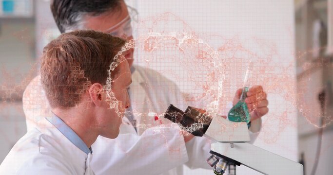 Leaning scientist peering into microscope in lab, mentor holding green flask with overlay, in coats