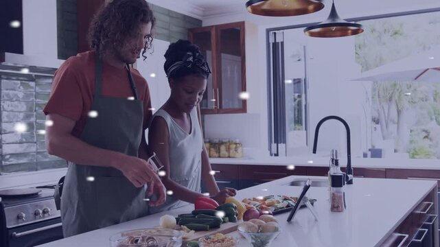 Man pointing tablet guiding woman arranging produce on island, speckled overlay aiding cooking