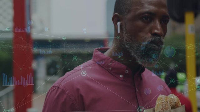 Mature man taking bite, snacking on handheld meal on sidewalk, gliding data overlays marking food