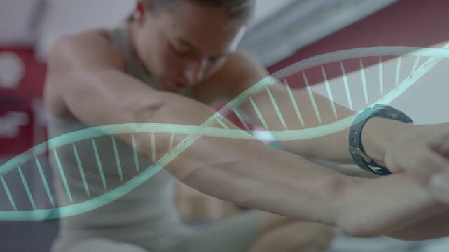 Grasping foot, athlete cooling down holding forward stretch in gym, teal helix sliding across face
