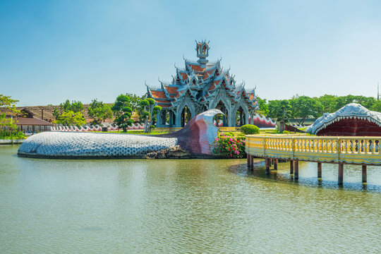 Sumeru Mountain Palace in a pond with giant mythical fish in Ancient City, Bangkok city, Thailand. Traditional Buddhist Thai temple in Ancient Siam. Architecture with traditional design