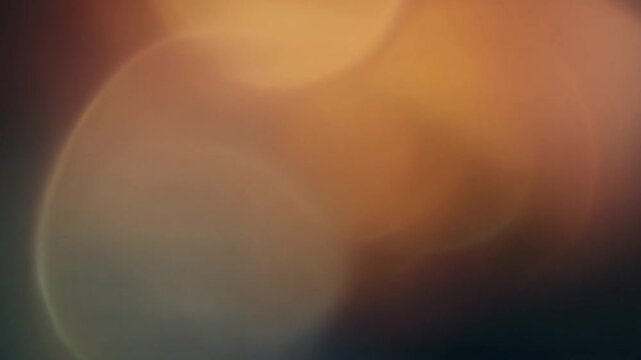 A gorgeous abstract 3D motion graphic loop displaying smooth, blurry horizontal shapes of warm orange, amber, and tan color washes blending together.