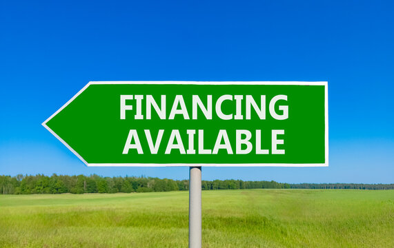 Financing available symbol. Concept words Financing available on beautiful green road sign. Beautiful blue sky green grass field background. Business financing available concept. Copy space.