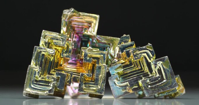 Bismuth crystals. Bismuth - chemical element with symbol Bi and atomic number 83. Post-transition metal and one of pnictogens. Synthesized bismuth crystal. Iridescent coloration is due to oxide film