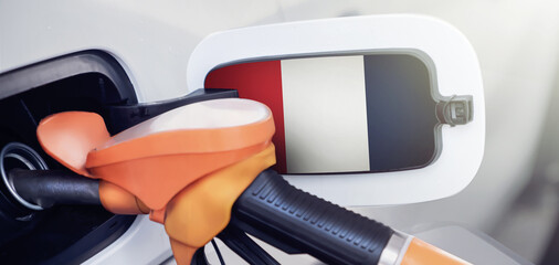 Fototapeta premium France flag on the lid of the gas tank of a car at a gas station in close-up. High or low prices for gasoline and diesel fuel at French gas stations. 
