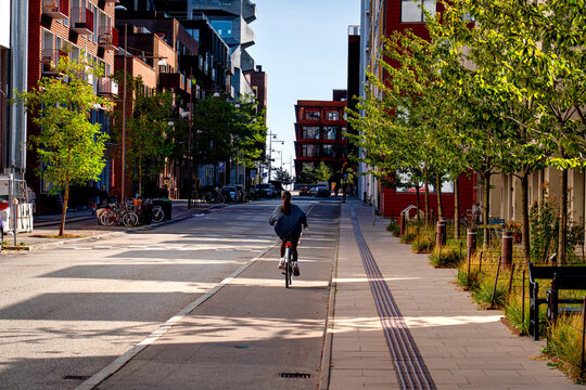 People on bikes in Nordhavn district Copenhagen on sunny day, life in Denmark.