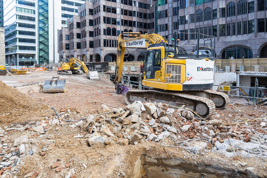Construction site with yellow excavator in the city. London, UK, 29 March 2024