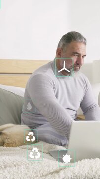 Vertical video: Floating icons causing senior user leaning and typing, sipping mug to check alerts