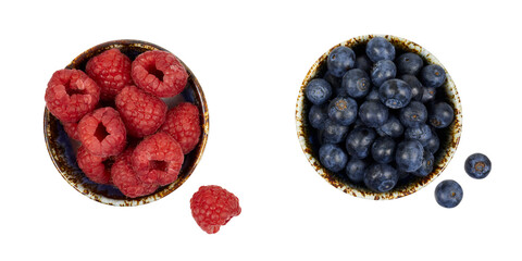 Plakat two bowls of fresh raspberries and blueberries ioslated on white or transparent png