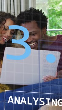 Vertical video: Couple viewing laptop, man lifting it and showing finance numbers, chart review
