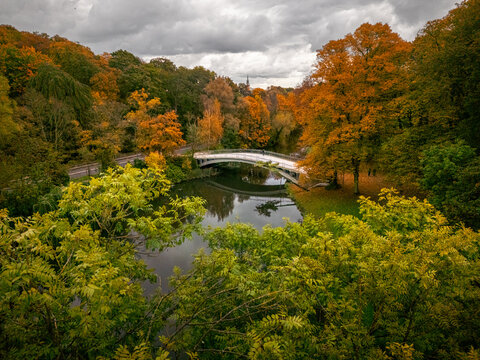 Autumn panorama and high angle view of the white Japanese Bridge over Rusalka in Kasprowicz Park, Szczecin, Poland.