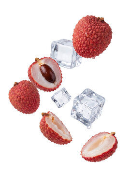 Exotic lychees and ice cubes falling, fresh tropical fruit and cooling elements isolated on a transparent background.
