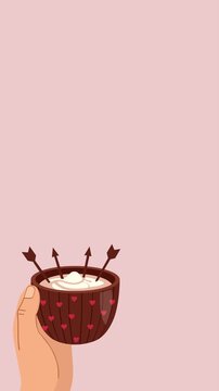 Hand Holding a Cup of Hot Drink Decorated with Cupid Arrows and Hearts