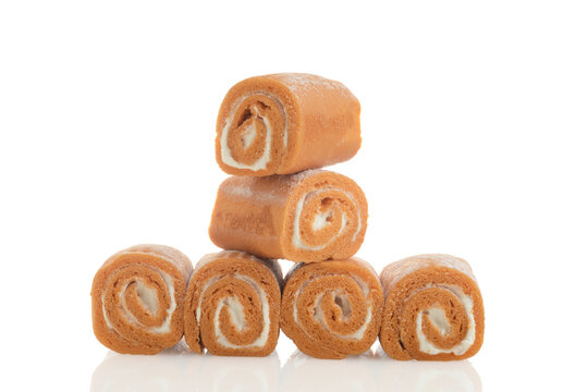 pile of orange and vanilla swiss roll cake