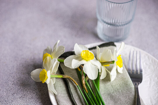 Close-up of a spring place setting with fresh daffodils