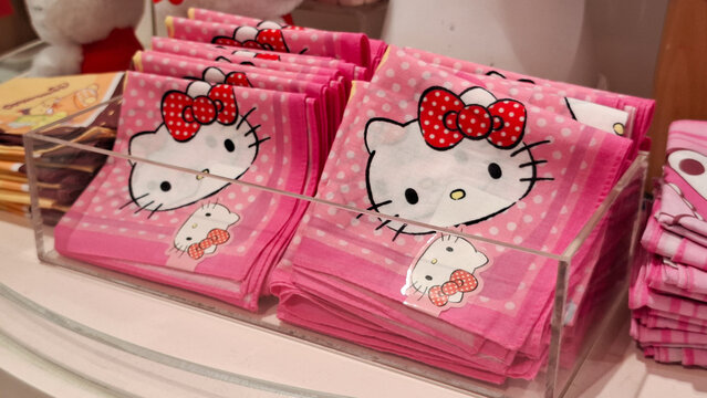 Official Sanrio Hello Kitty character merchandise featuring branded textile handkerchiefs and plush dolls displayed in a gift shop on April 18, 2026 in Bangkok, Thailand