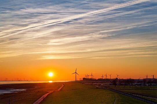 Distant view of wind turbines along the river Ems, East Frisia, Lower Saxony, Germany