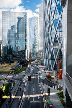 Empty Paris street and road stretch toward modern skyline towers in urban France where infrastructure lines and restrained architecture feel cinematic