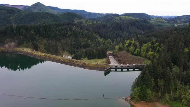 4K aerial drone footage of Yale Lake dam and hydroelectric power plant on the Lewis River in Washington, USA. Wide view of reservoir, forested hills and flowing water in Pacific Northwest landscape