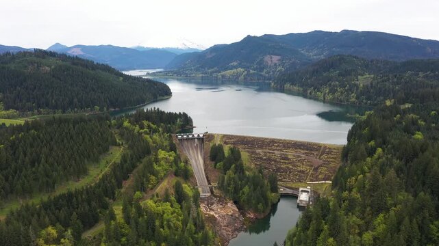 4K aerial drone footage of Yale Lake dam and hydroelectric power plant on the Lewis River in Washington, USA. Wide view of reservoir, forested hills and flowing water in Pacific Northwest landscape