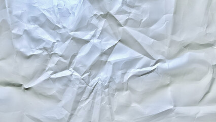 Fototapeta premium intricately crumpled white paper texture with deep folds subtle shadows and irregular creases on plain backdrop