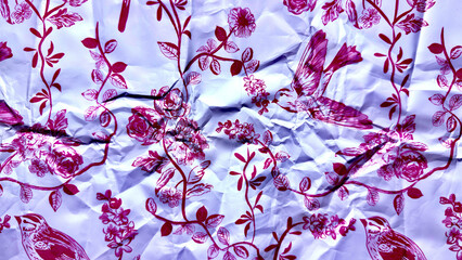 Fototapeta premium crumpled magenta hummingbird fluttering among intricate rose vines on wrinkled lavender paper texture evoking whimsical vintage charm