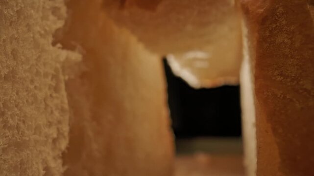 Detailed macro view of white bread crumb showing porous airy texture and crispy crust. Concept of homemade food, bakery products, bakeries and bread factories, market, gastronomy and culinary art