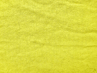 Fototapeta premium vibrant yellow corduroy fabric texture closeup showcasing fine parallel ridges and soft velvety surface in warm golden hues