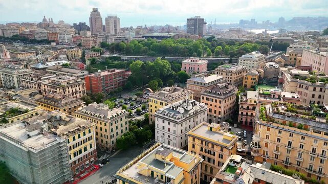 Spectacular aerial panorama of Genoa city nestled between the Mediterranean sea and mountains, Italy.