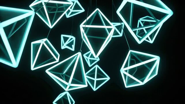 Panning camera showing glowing cyan tetrahedral frames rotating in black studio, revealing cords