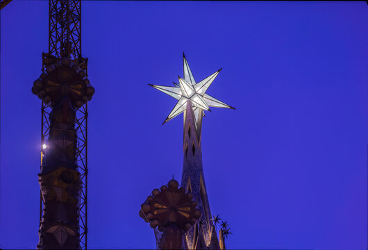 New star on the tower of the Virgin Mary in the Basilica of the Sagrada Familia. the second tallest of Barcelona iconic church. Exterior shot from public floor. Night view.