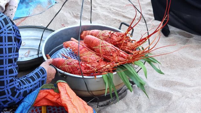Fresh grilled spiny lobster seafood on tropical beach market. Street food vendor selling barbecue shellfish to tourists on Asian seaside, coastal cuisine concept