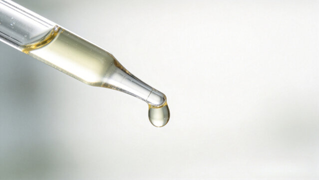 Glass pipette dispensing liquid fertilizer
